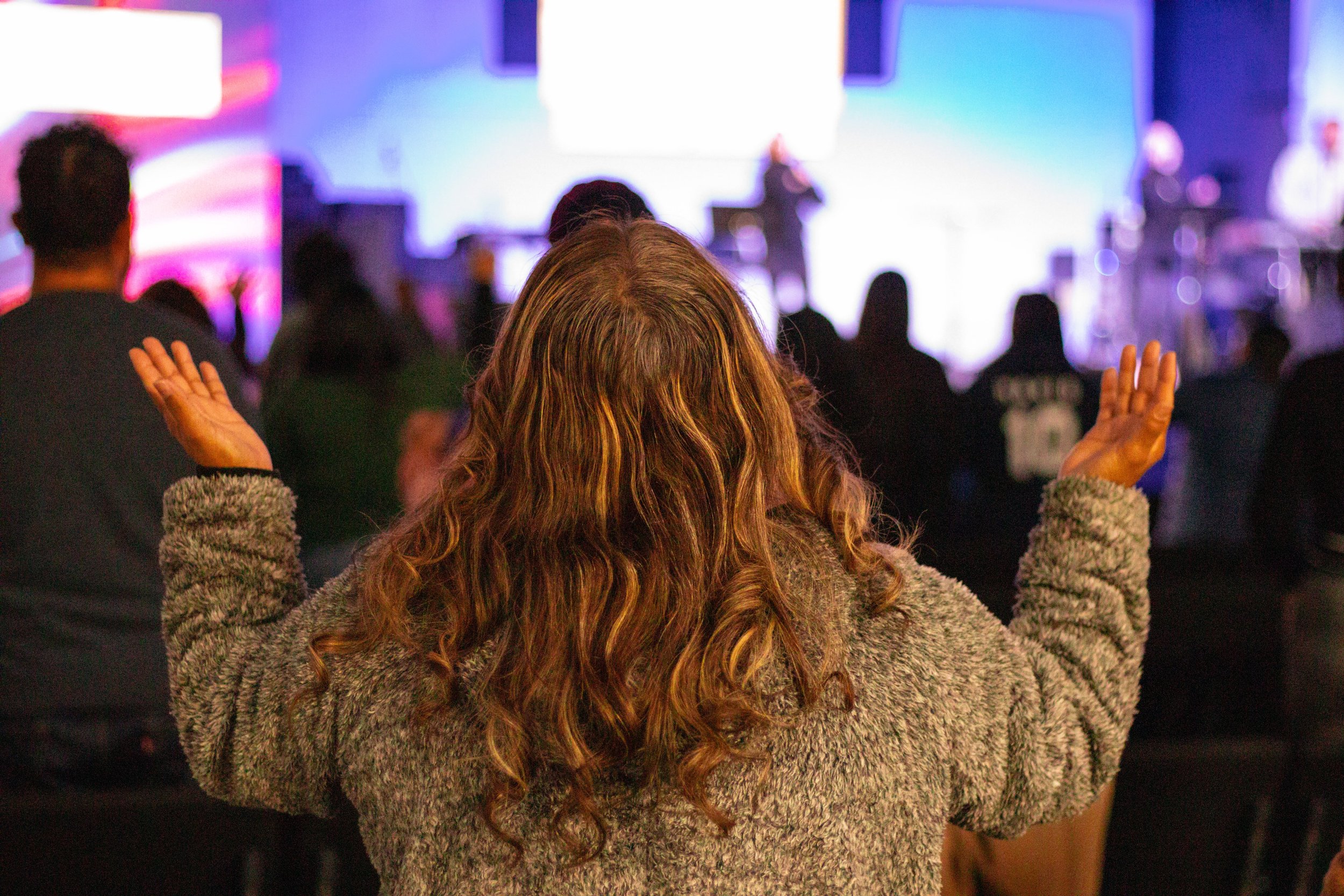 Worshiper with raised hands at a church service
